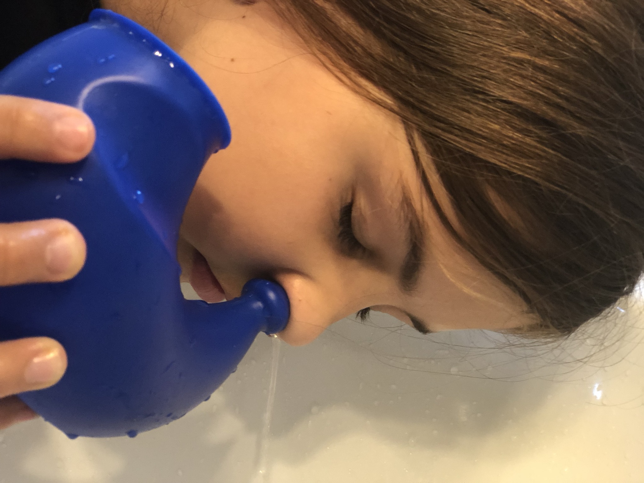 Djevojčica primjenjuje sustav za ispiranje nosa